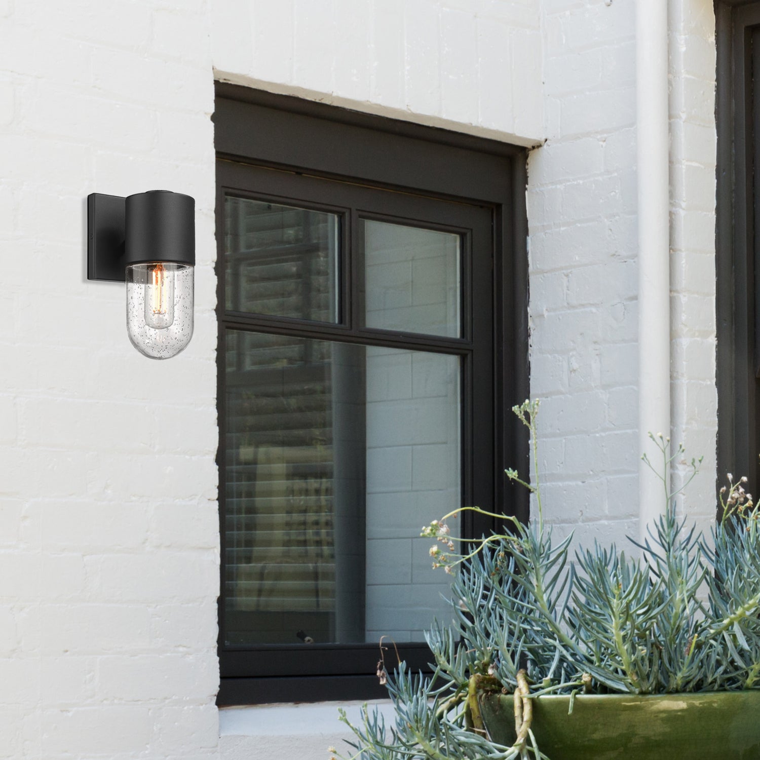 Ezra 1 Light Wall Sconce - Outdoor in Natural Black with Seeded Glass Shade