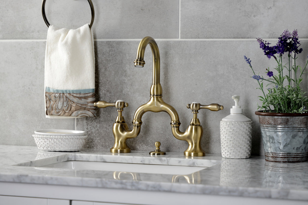 Kingston Brass KS7993TAL Tudor Bridge Bathroom Faucet with Brass Pop-Up, Antique Brass