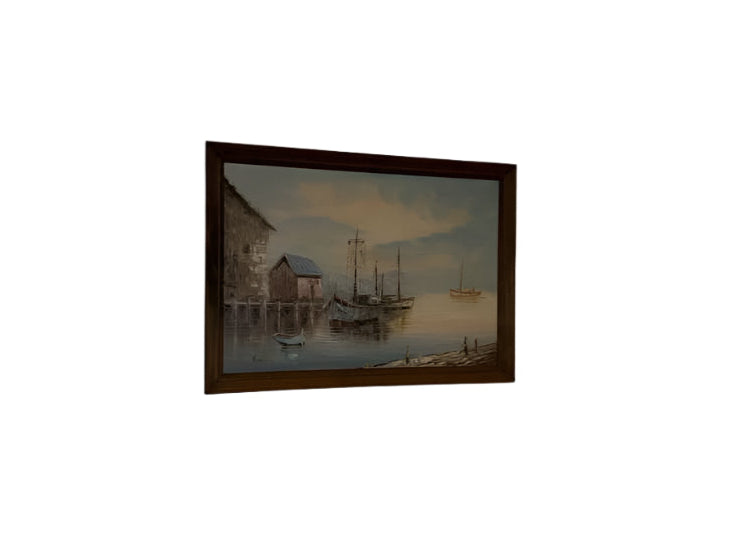 Framed artwork of a coastal scene with boats and buildings.