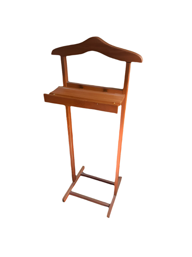 Wooden step stool on a floral rug with a fireplace and window in the background
