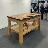 Wooden dining table with a bench in a showroom setting
