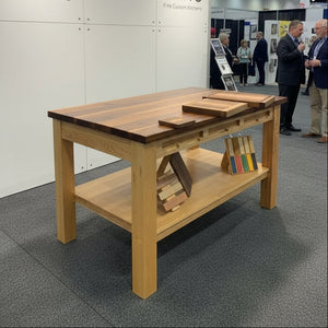 Wooden dining table with a bench in a showroom setting