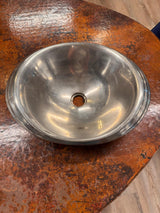 Metallic bowl on a rusty surface