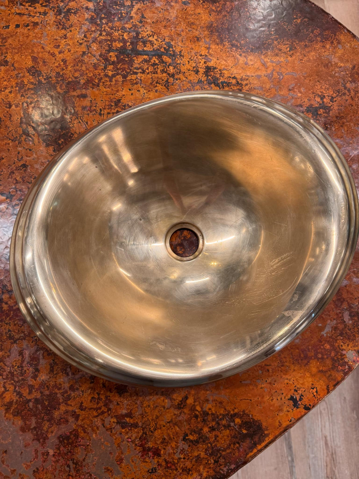 Metallic bowl on a rusted surface