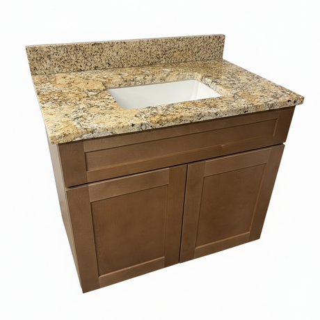 Bathroom vanity with granite countertop and white sink on a wooden floor.