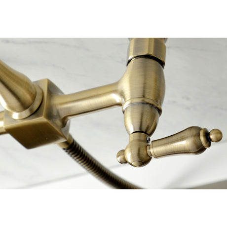 Heritage KS1243ALBS Two-Handle 2-Hole Wall Mount Bridge Kitchen Faucet with Brass Sprayer, Antique Brass