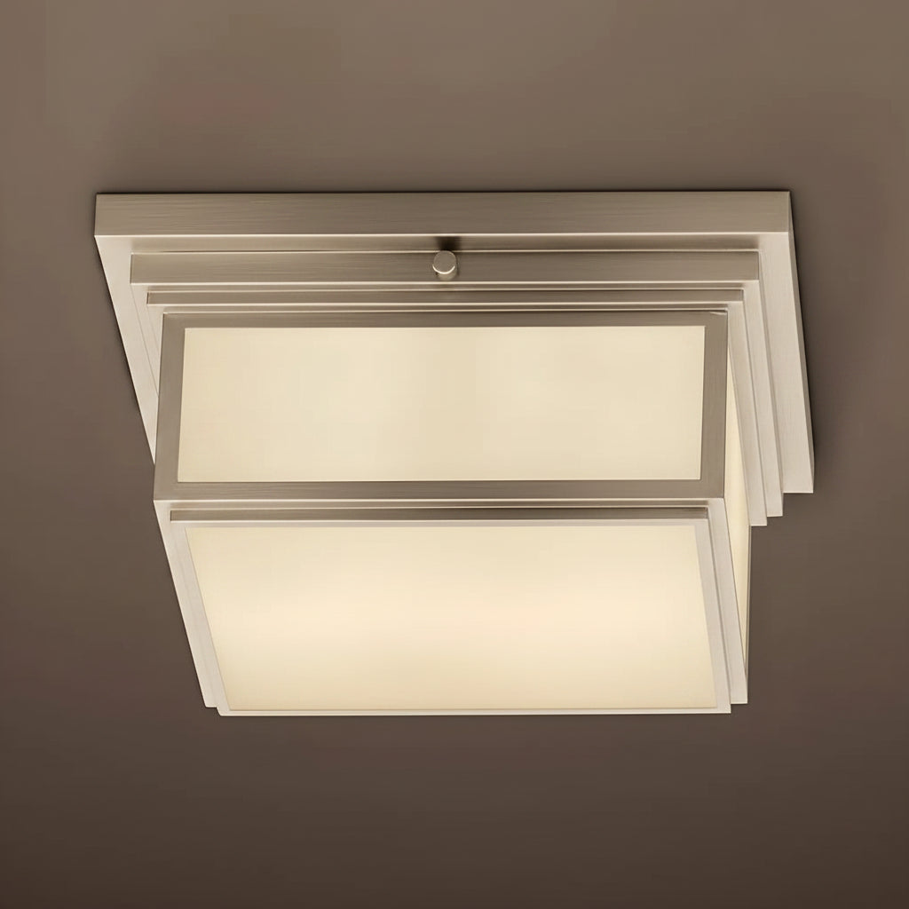 Modern ceiling light fixture with white glass shades on a brown background
