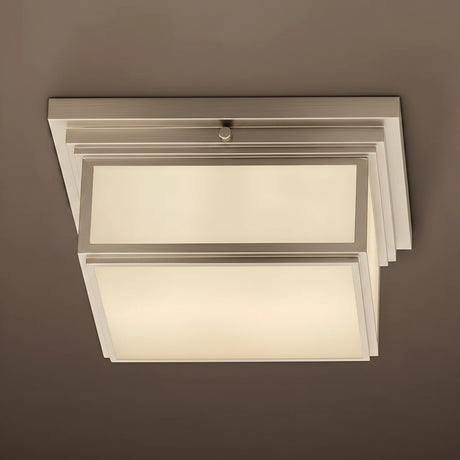 Modern ceiling light fixture with white glass shades on a brown background
