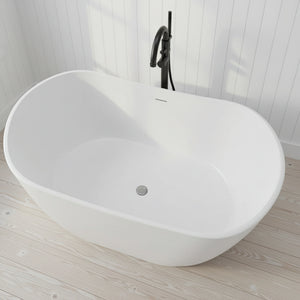 White freestanding bathtub with a modern faucet against a gray wall.