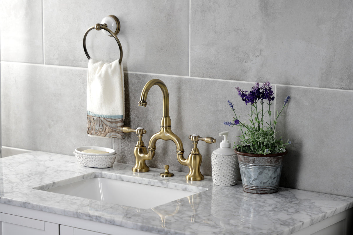 Kingston Brass KS7993TAL Tudor Bridge Bathroom Faucet with Brass Pop-Up, Antique Brass