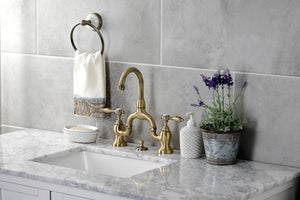 Kingston Brass KS7993TAL Tudor Bridge Bathroom Faucet with Brass Pop-Up, Antique Brass