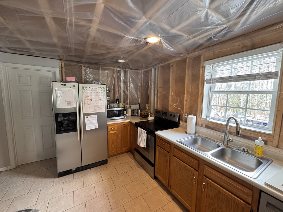 Before: original oak cabinets, light countertops and double-bowl sink during the Goffstown renovation