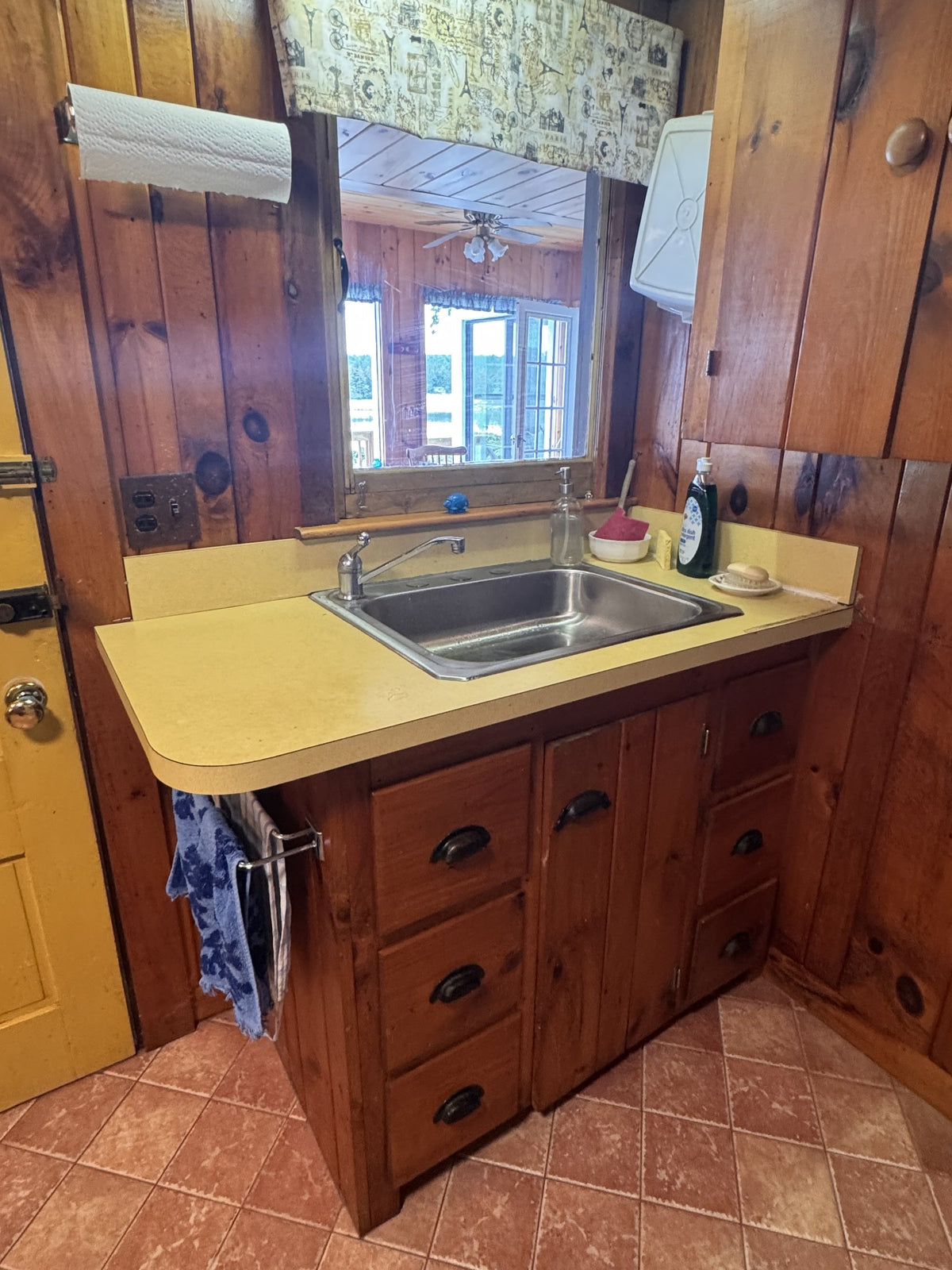 Before: original yellow laminate countertop and drop-in sink in the Stoddard lakefront cottage kitchen