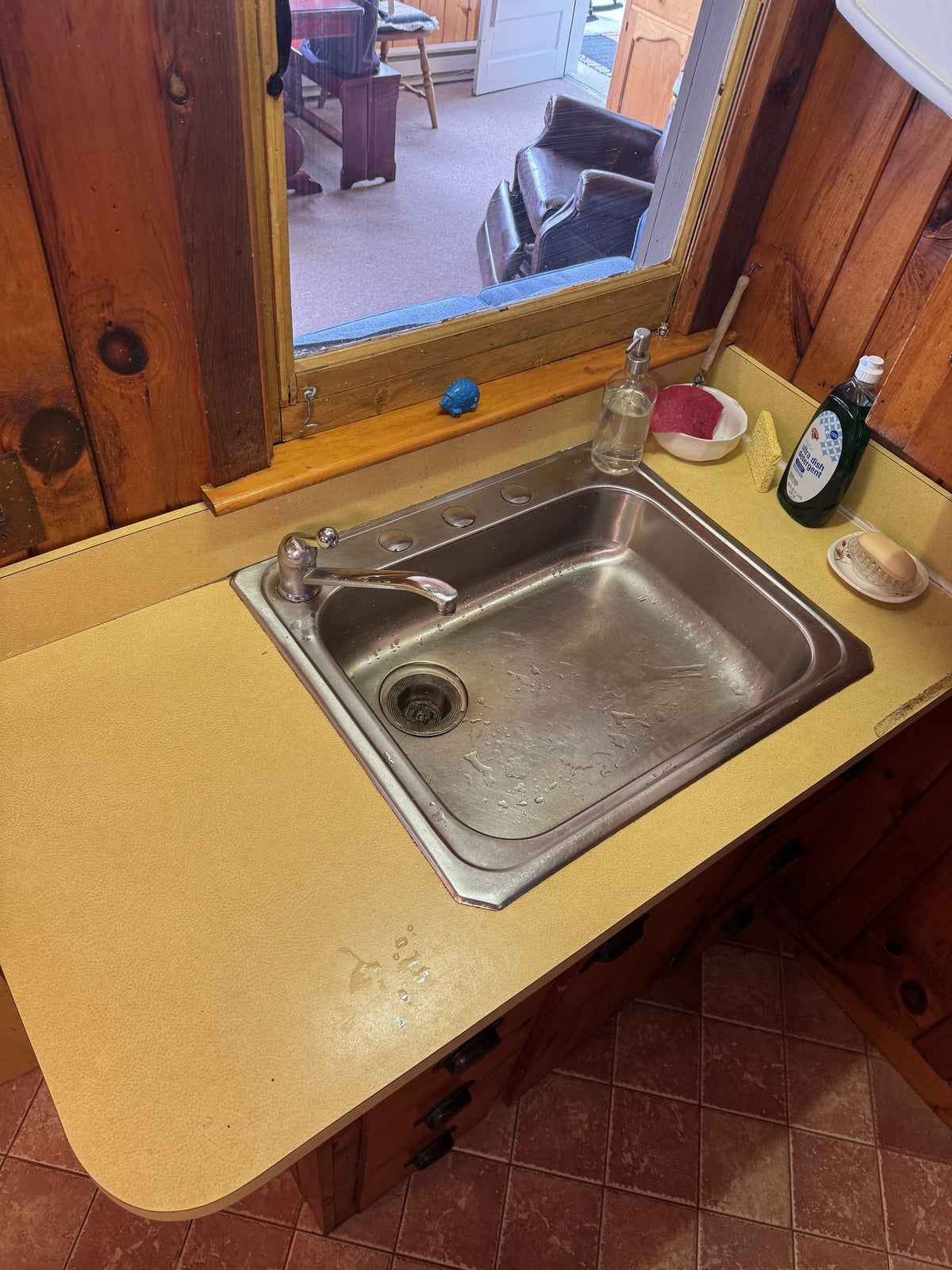 Before: close-up of the original yellow laminate counter and stainless drop-in sink