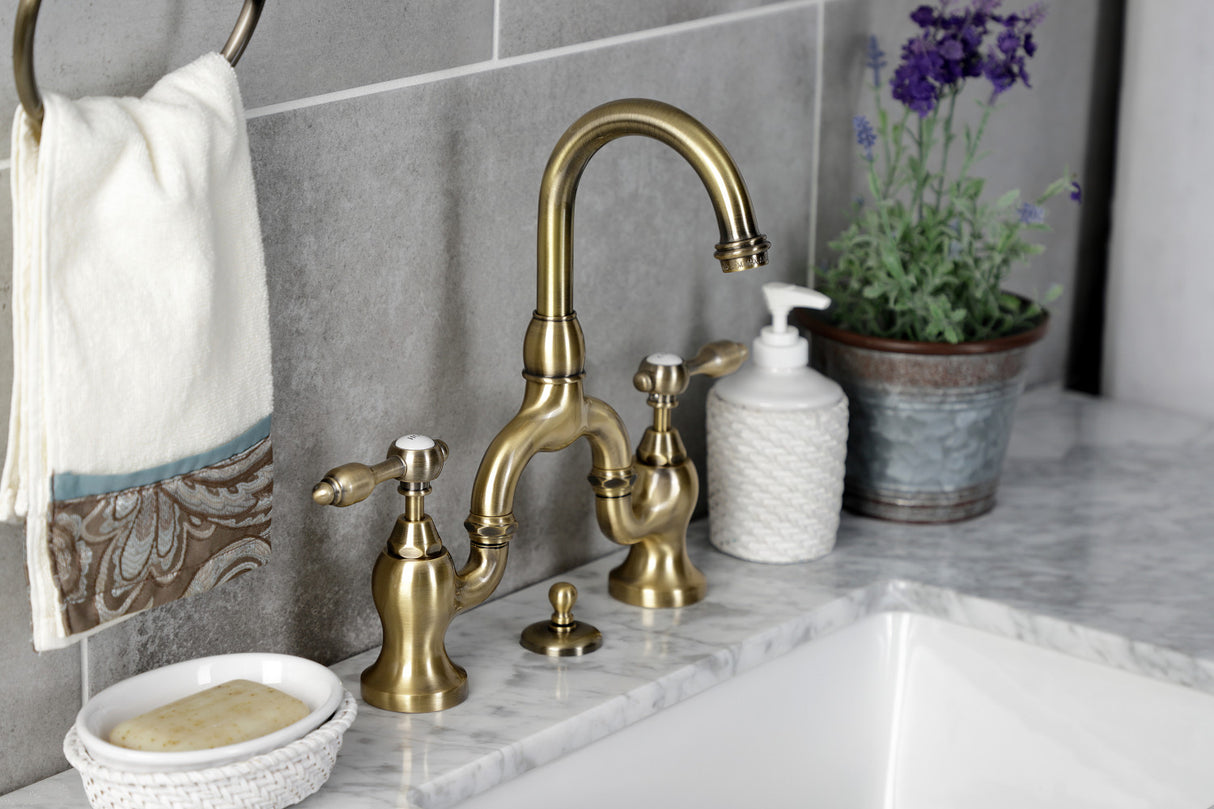 Kingston Brass KS7993TAL Tudor Bridge Bathroom Faucet with Brass Pop-Up, Antique Brass
