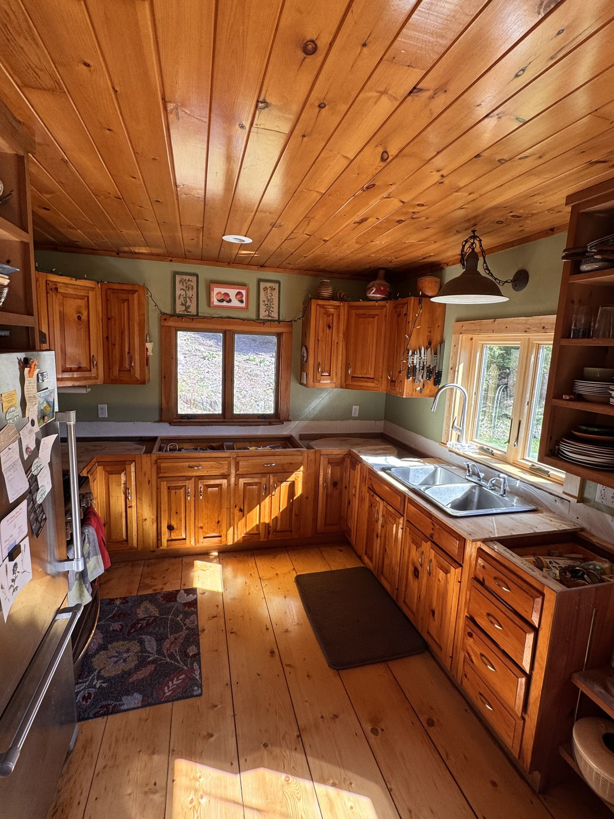 Before: the Vermont cottage kitchen with its original countertops and knotty-pine cabinetry