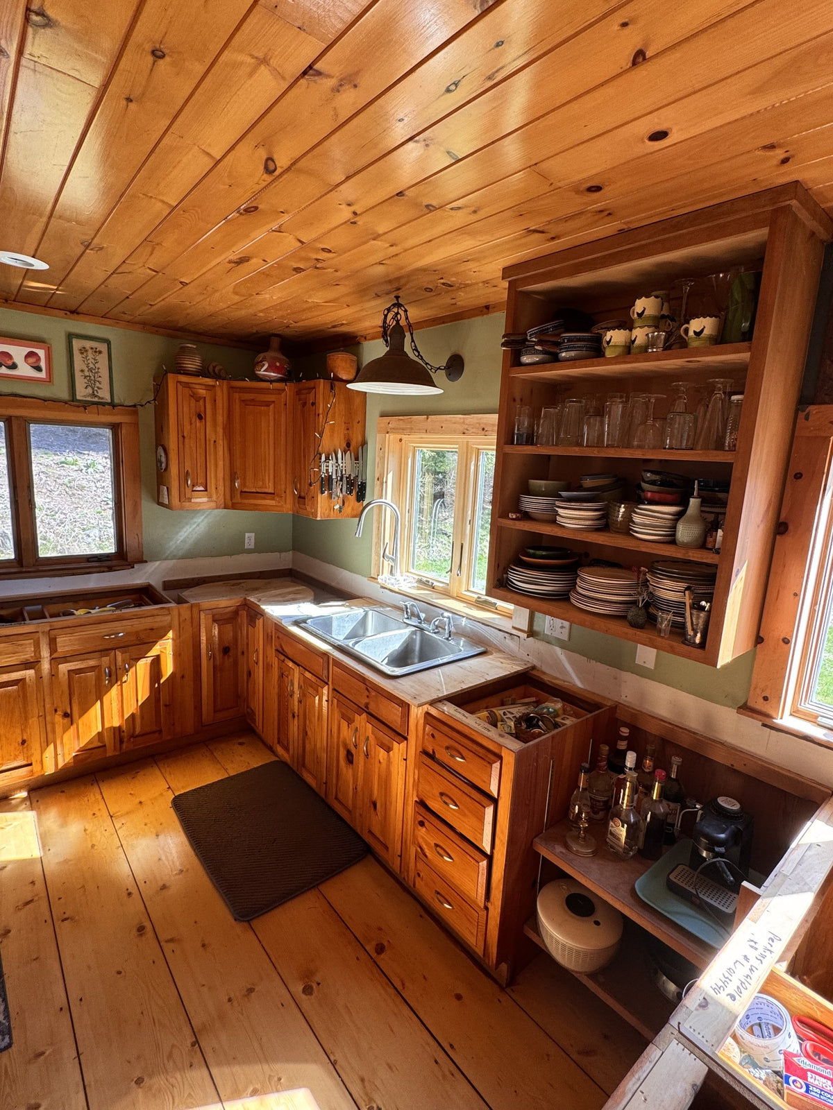 Before: original Vermont cottage kitchen countertops, sink and window wall